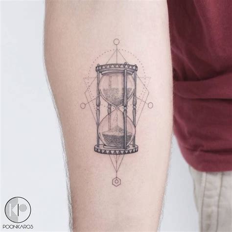 A Man With A Tattoo On His Arm Has An Hourglass In The Shape Of A Diamond