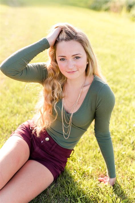 Senior Girl Wearing Green Top And Red Shorts Country Styled High School Senior Pictures On A F