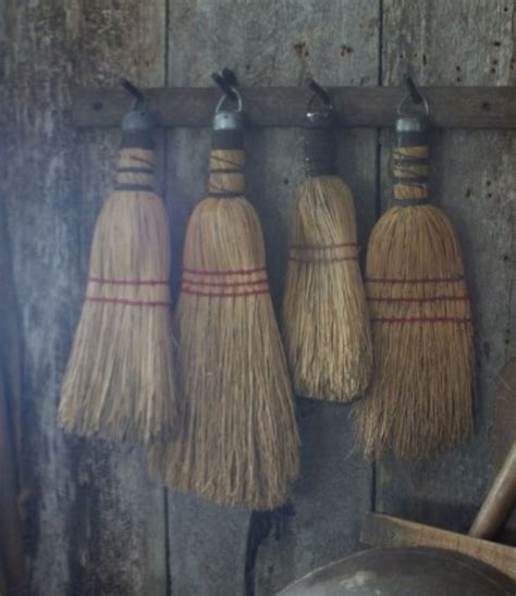 Three Brooms Are Hanging On The Wall
