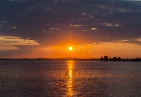 Orange Sunset Over A European Lake Blue Clouds Sky Colored Dra Stock