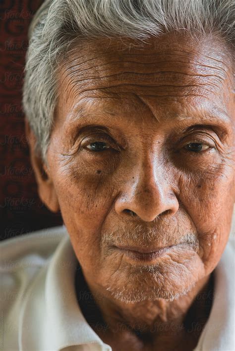 asian old man sitting on chair by stocksy contributor chalit saphaphak stocksy