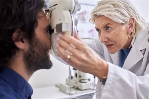 Doctor With A Man In Vision Test Or Eye Exam For Eyesight By A Focused