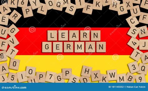 Learn German Word Written With Wooden Tiles Over German Flag Stock