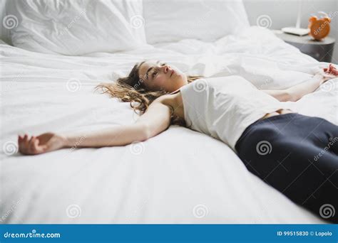 Beautiful Young Woman With Long Hair Sleeping On Bed In Bedroom Stock
