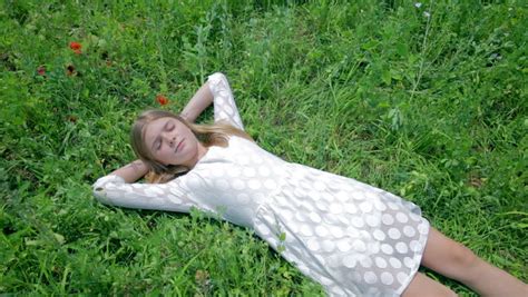 Girl In White Dress Lay In Grass Waking Up Stock Footage Video 6633977