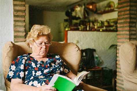 Senior Woman Reading In Her Living Room Del Colaborador De Stocksy Kkgas Stocksy