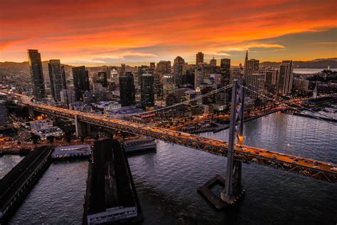 Top View Photo Of Bridge And High Rise Buildings During Sunset Bay