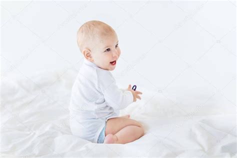 Baby Boy Sitting On Bed — Stock Photo © Lenamiloslavskaya 151259908