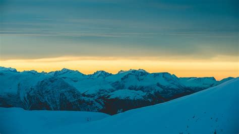 Download Wallpaper 1366x768 Mountains Snow Sunset Horizon Sky