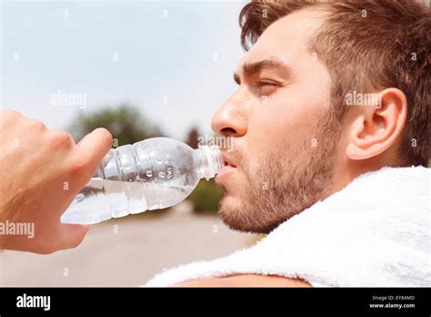 Handsome Guy Drinking Water Stock Photo Alamy