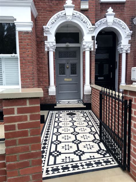 Victorian Mosaic Tile Path With Black And White Tiles Red Brick Wall