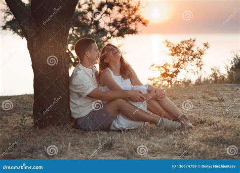 A Couple Is Sitting Under A Tree Stock Image Image Of Love Together