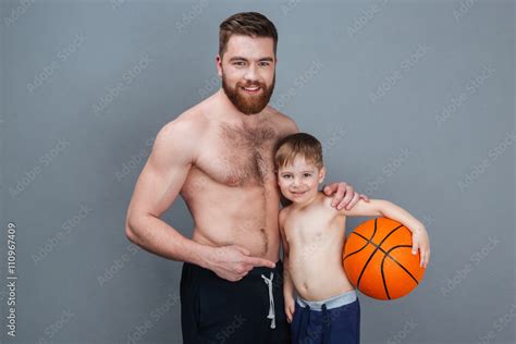 Happy Shirtless Dad And Son Holding Basketball Ball Stock Photo Adobe