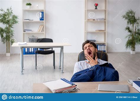 Young Male Employee Extremely Tired In The Office Stock Photo Image