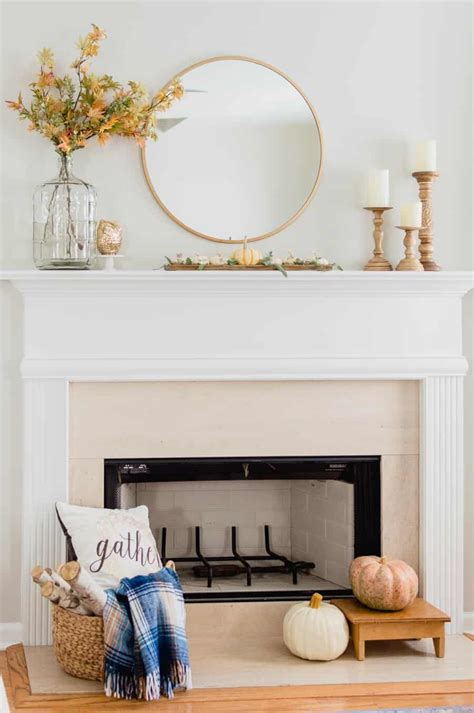 White neoclassical parisian fireplace with two white french sitting chairs, parquet flooring and crystal chandelier. 25 Inspiring Fall Mantel Decorating Ideas | A Blissful Nest