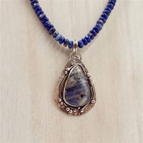A Beautiful Blue Jasper Gemstone Is Set In A Hammered Sterling Pendant