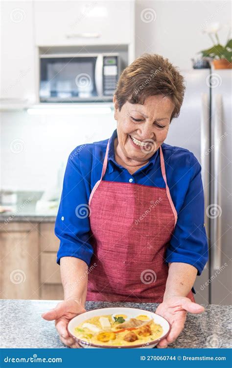 Granny Smiling Serving Soup In The Kitchen Stock Photo Image Of Indoor Working
