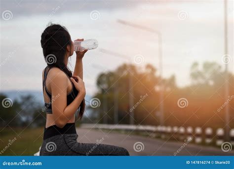 Attractive Healthy Fitness Girl Drinking Water After Workout Runner