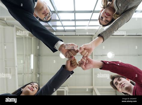 Team Building Concept Coworkers Standing In Circle Bumping Fist Together Celebrating Business