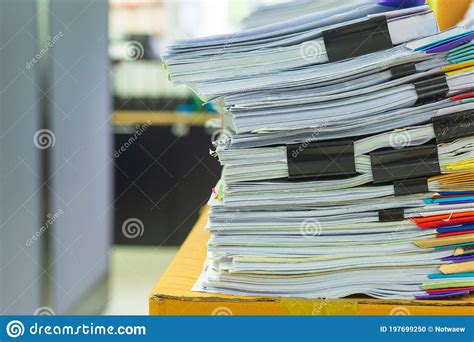 Pile Of Documents On Desk Stack Up High Waiting To Be Managed Stock