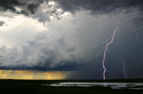 Lightning Cracks In A Cloud Filled Sky Photograph By Randy Olson