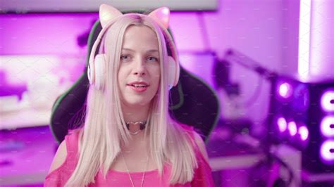 Cute Blonde Gamer Girl With Cat Ear Headphones In Cyberspace Talking To