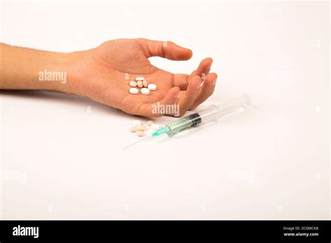 Drug Addiction Concept Passive Hand With Coat Pills And Injection