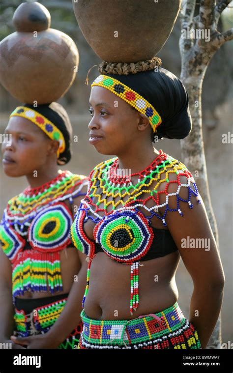 Zulu Girls Wearing Traditional Beaded Dress And Carrying Pots On Their