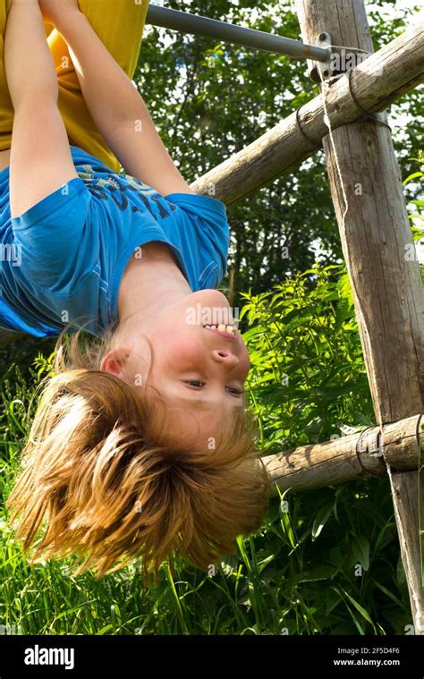 Active Child Upside Down Fun Laughter Fooling Around In Nature Stock