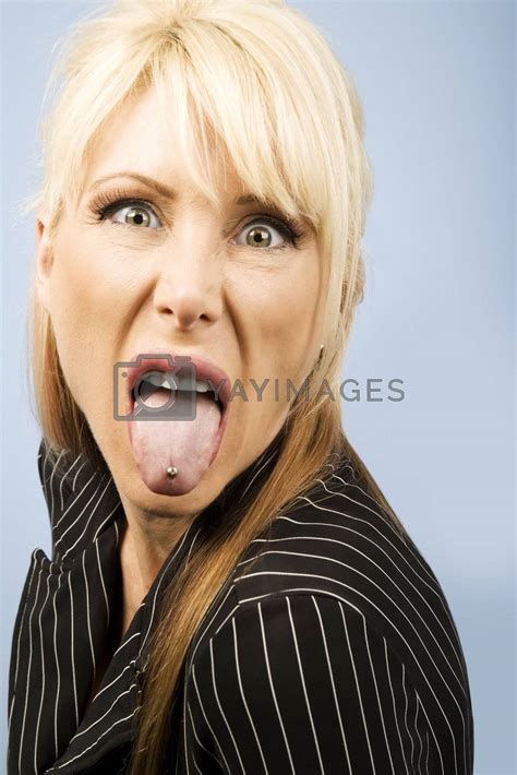 royalty free image woman sticking out her pierced tongue by creatista