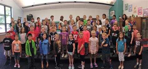 Older teenager solving fractions and doing math on a board. Music With Mr. Barrett: C H O R U S