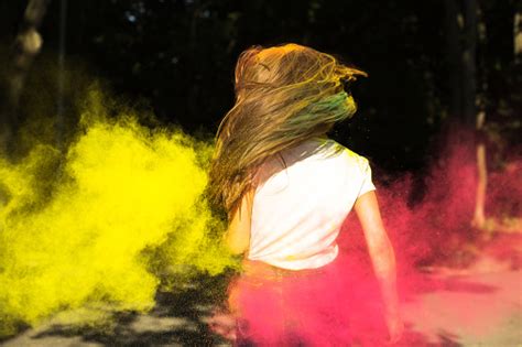 Slim Blonde Woman With Wind In Hair And Vibrant Colors Exploding Around