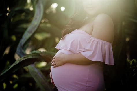 Pregnant Mom To Be Posing Near Large Succulent Photograph By Cavan Images