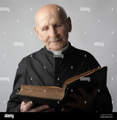 Portrait Of A Old Priest With Bible Stock Photo Alamy