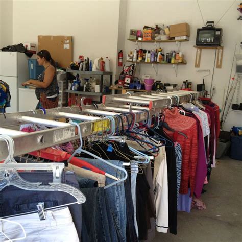 Use items you're selling for storage. Garage Sale Tip: use an extension ladder to hang clothes ...