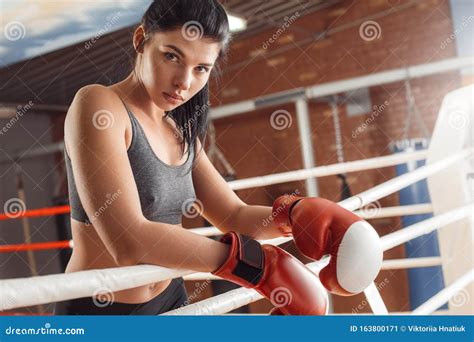 Boxing Woman Boxer In Gloves Leaning On Rope On Ring Looking Camera