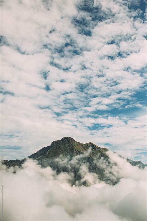 Mountain Peak Surrounded By Clouds By Stocksy Contributor Michela
