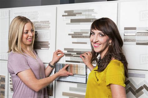 Interior Designer And Design Consultant Selecting Tiles And Grout In