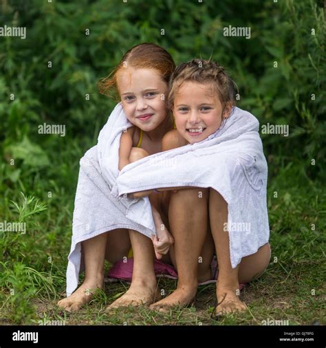 Deux Petites Filles Coquines Assis Sur La Plage Dans Une Serviette