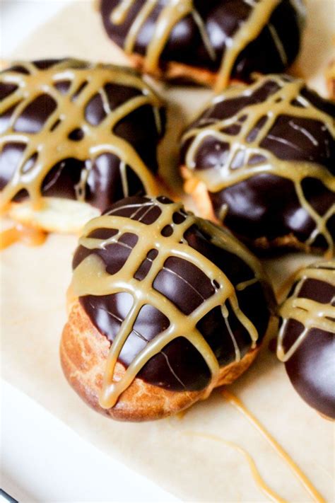 choux pastry profiteroles filled with salted caramel cream glazed with dark chocolate and