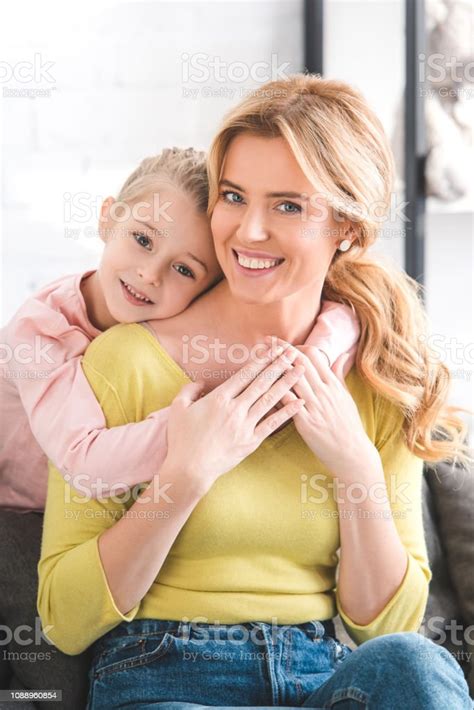 Beautiful Happy Mother And Daughter Hugging And Smiling At Camera Stock
