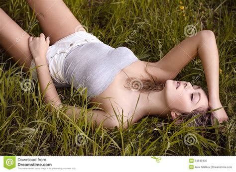 Beautiful Girl Lying On The Grass In The Park With His