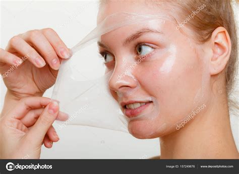 Woman Removing Facial Peel Off Mask Stock Photo By ©voyagerix 157249676