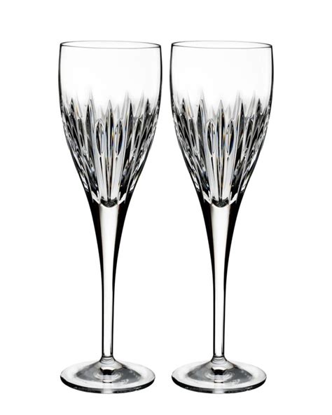 Two Wine Glasses Sitting Next To Each Other