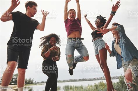 Celebrate While Jumping Group Of People Have Picnic On The Beach