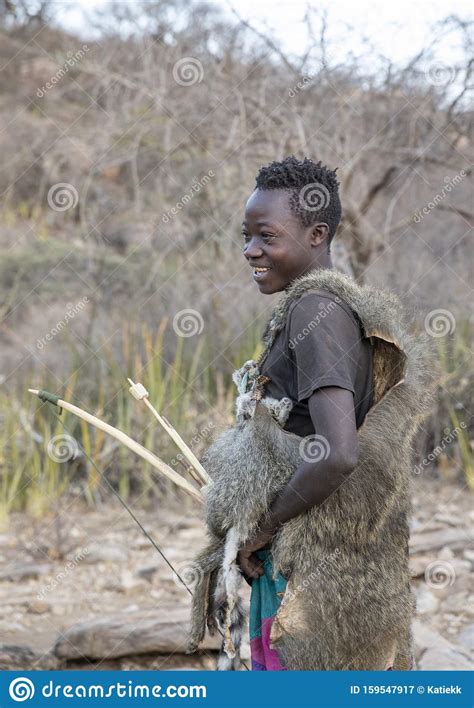 hadzabe man with his bow and arrow going for a hunt editorial photography image of maasai