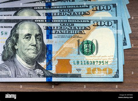 New Hundred Dollar Bills On Wooden Background Stock Photo