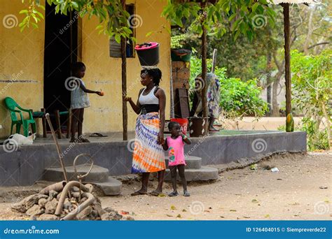 unidentified local woman carries a bucket on her head in a vill editorial image image of