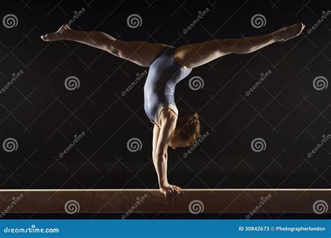 Gymnast Doing Split Handstand On Balance Beam Royalty Free Stock Photo