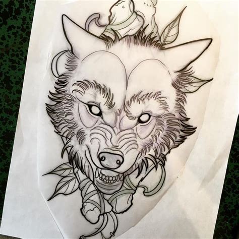 A Drawing Of Two Wolf Heads On Top Of A Piece Of Paper